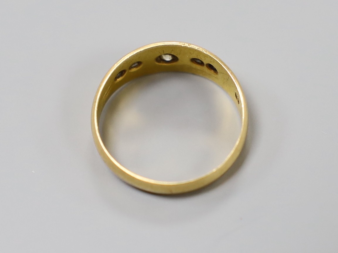 A late Victorian 18ct gold, single stone diamond and four stone sapphire gypsy set ring, size N, gross weight 3.2 grams.